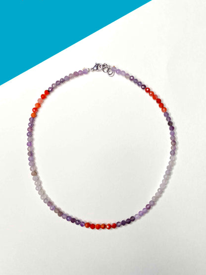 Handmade purple and orange mixed gemstone bead necklace with a sterling silver clasp.