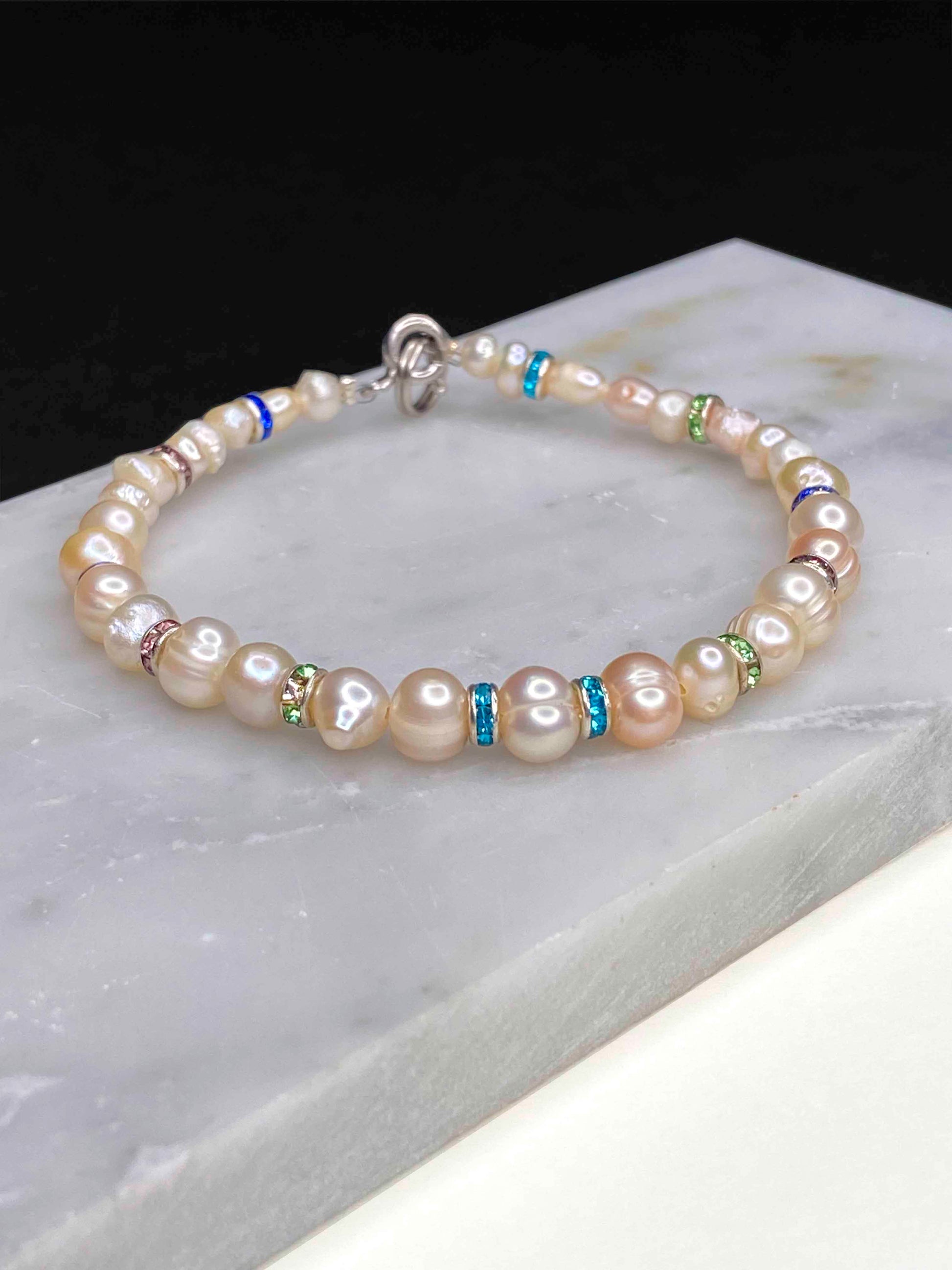 Handmade beaded pearl bracelet with rhinestone spacers. 