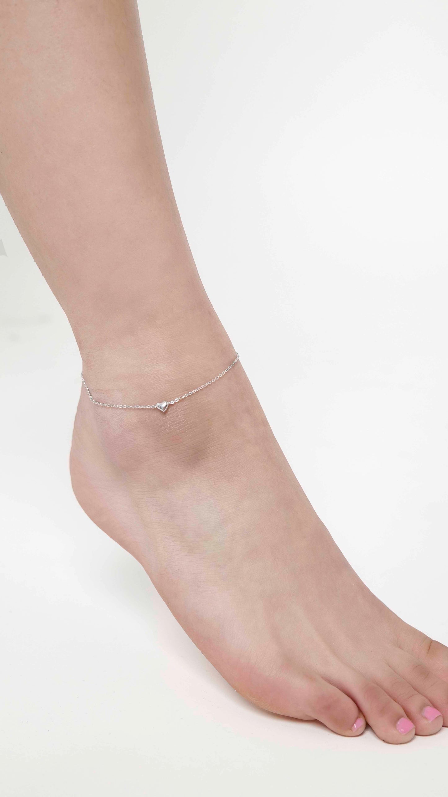 Sterling silver link chain anklet with a heart charm.