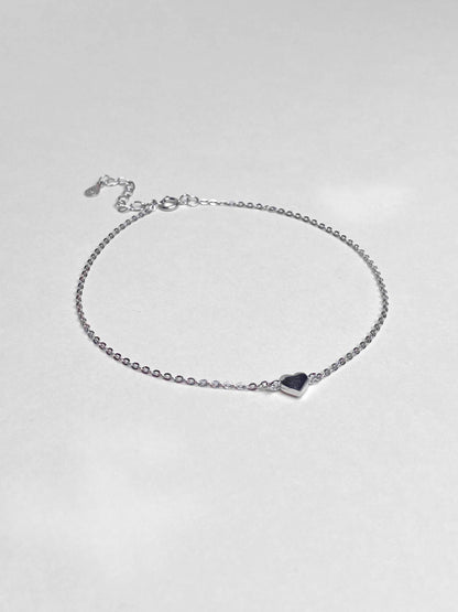 Sterling silver link chain anklet with a heart charm.