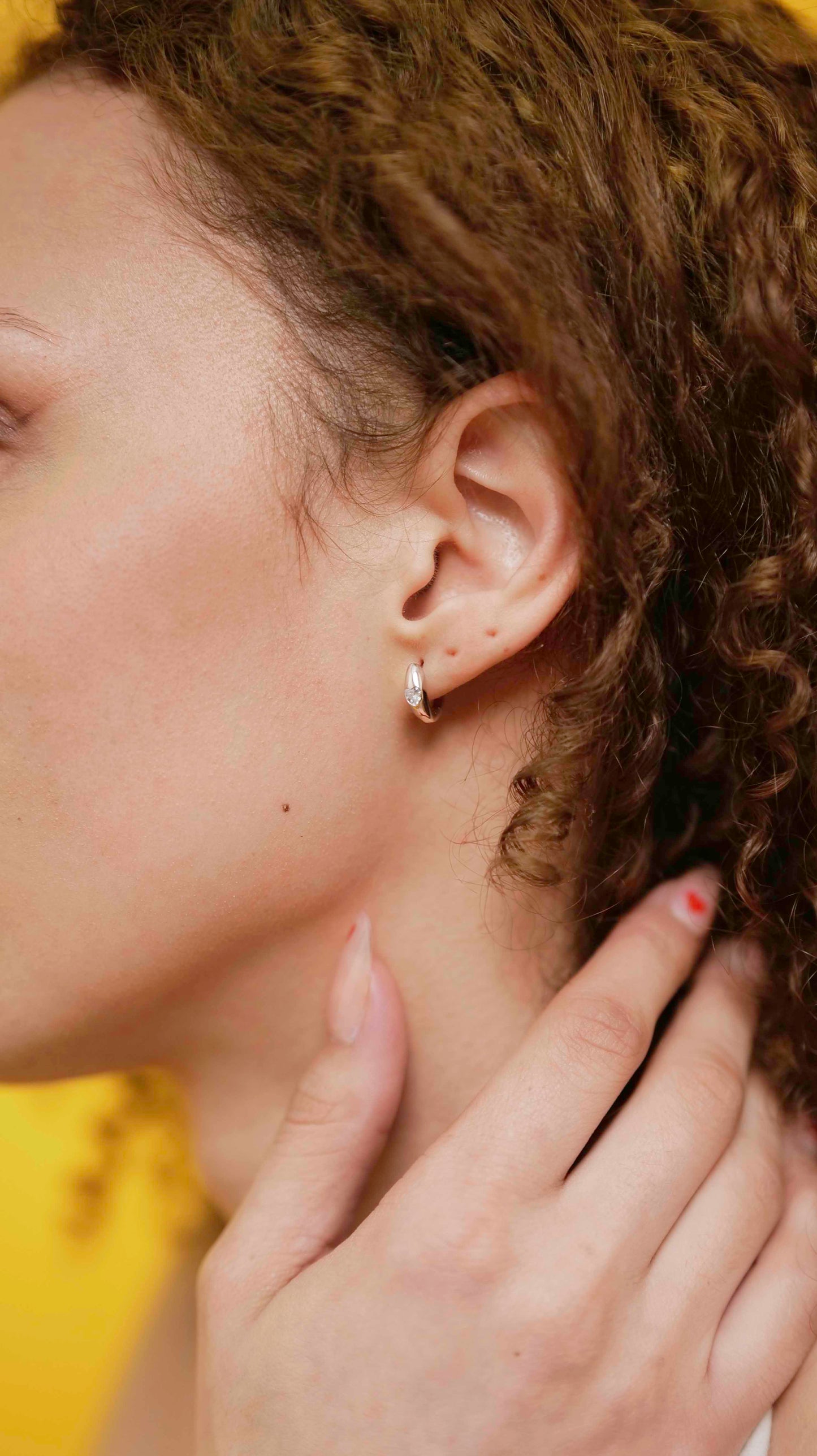 Sterling silver hoop earrings with heart-shaped zircon stone.