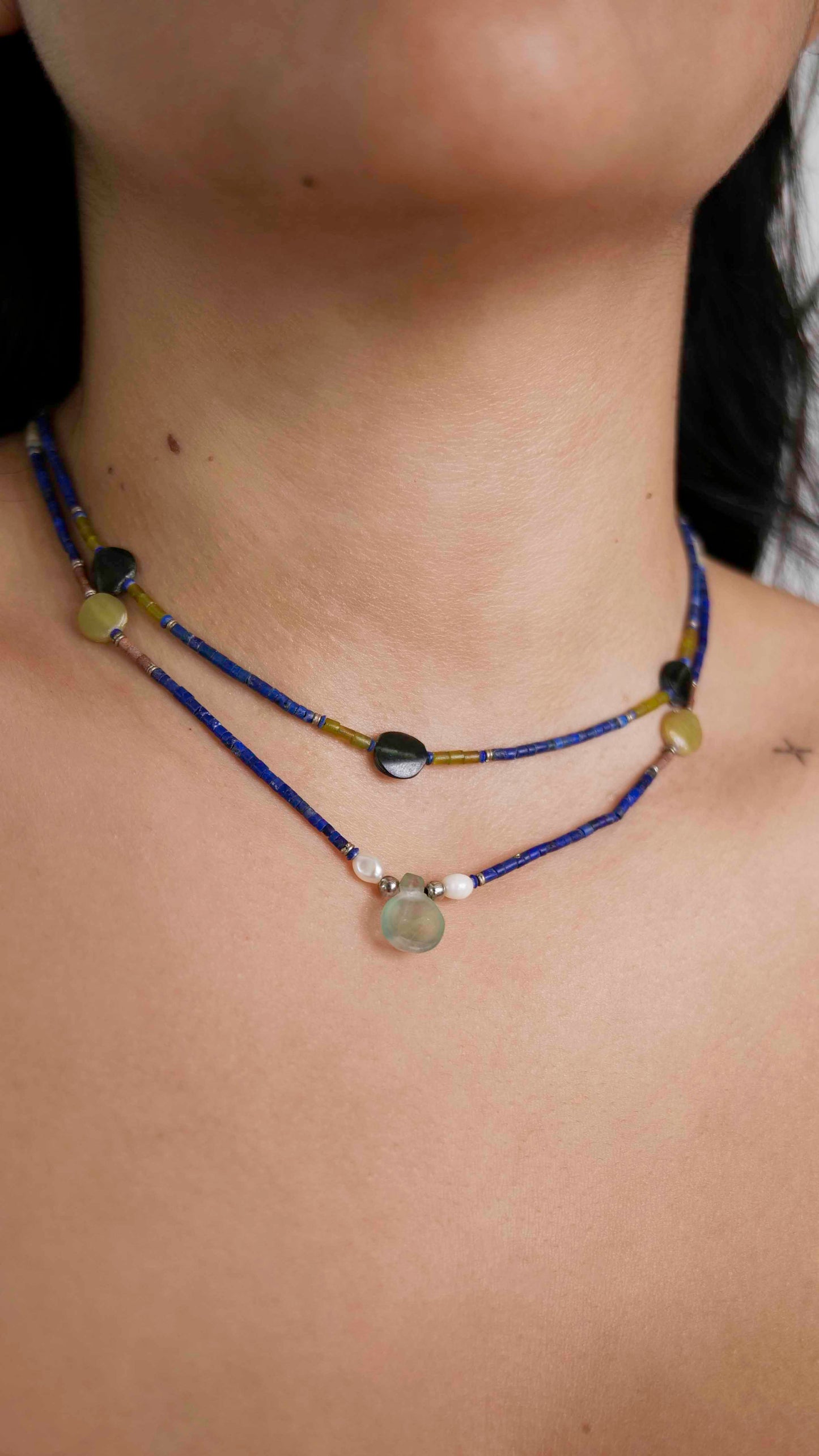 Handcrafted vintage necklaces that feature green quartz, pearls, granite, black tourmaline, and lapis lazuli stones with 925 sterling silver balls and clasp.
