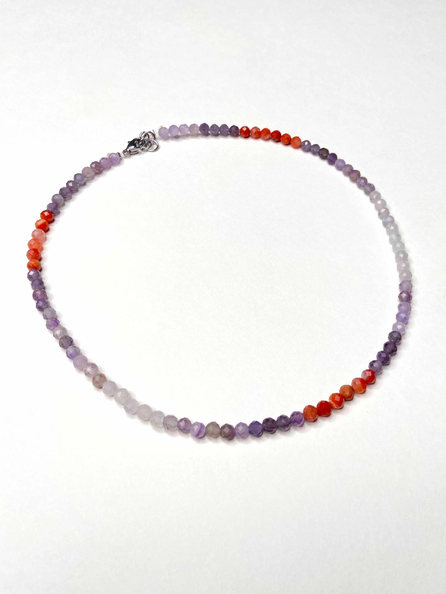 Handmade purple and orange mixed gemstone bead necklace with a sterling silver clasp.