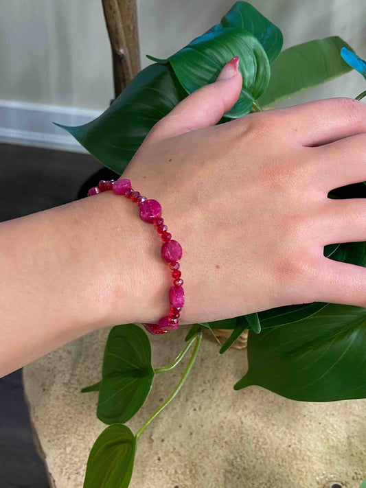 A handmade red crystal bead and pink rubellite stone bracelet.  