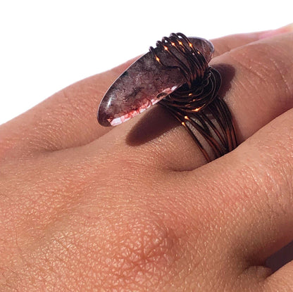 handcrafted wire wrapped ring made using brown wires and a tourmaline gemstone 