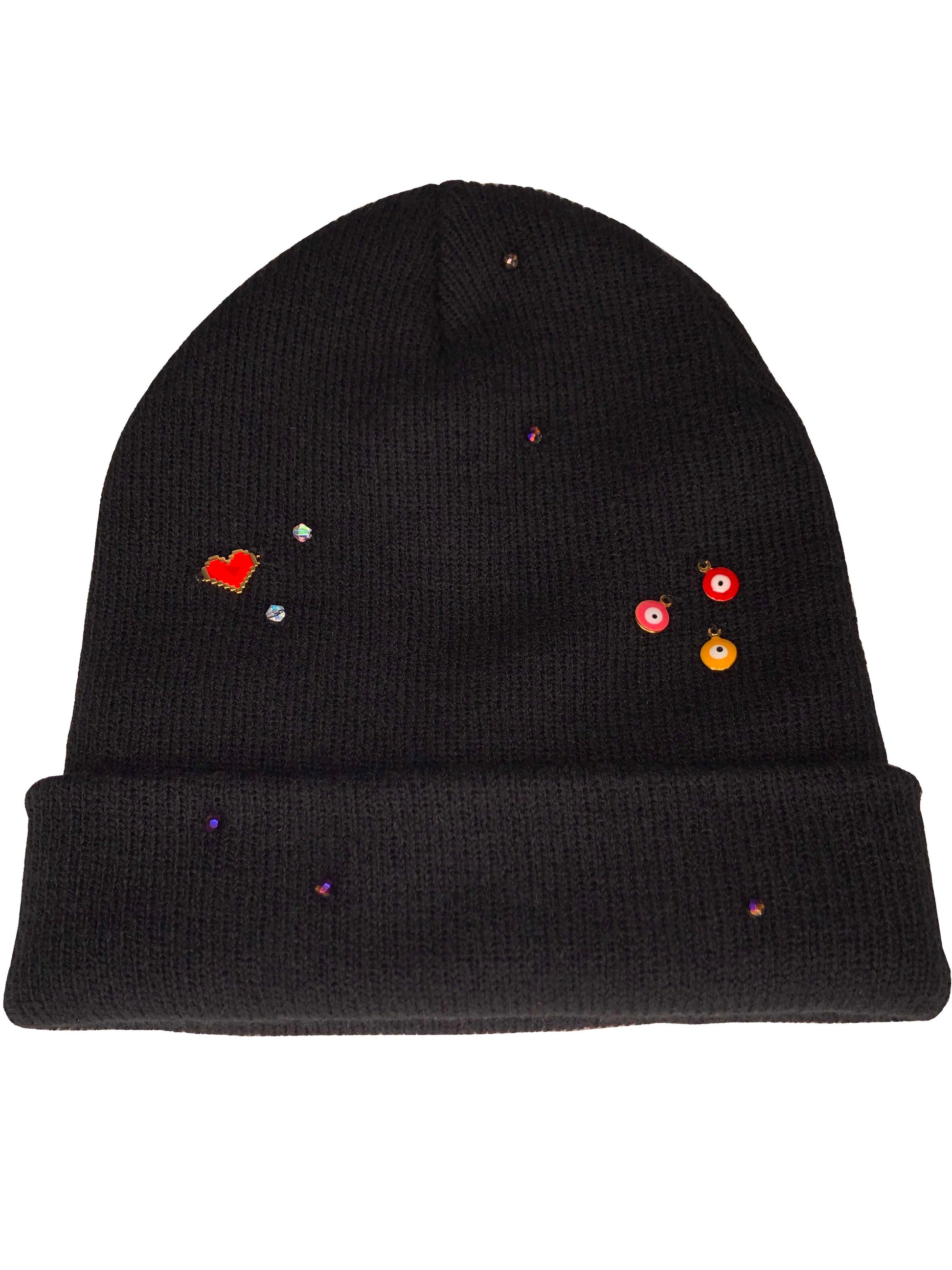 A black beanie accessorized using beads, evil eye charms, and crystal beads. 
