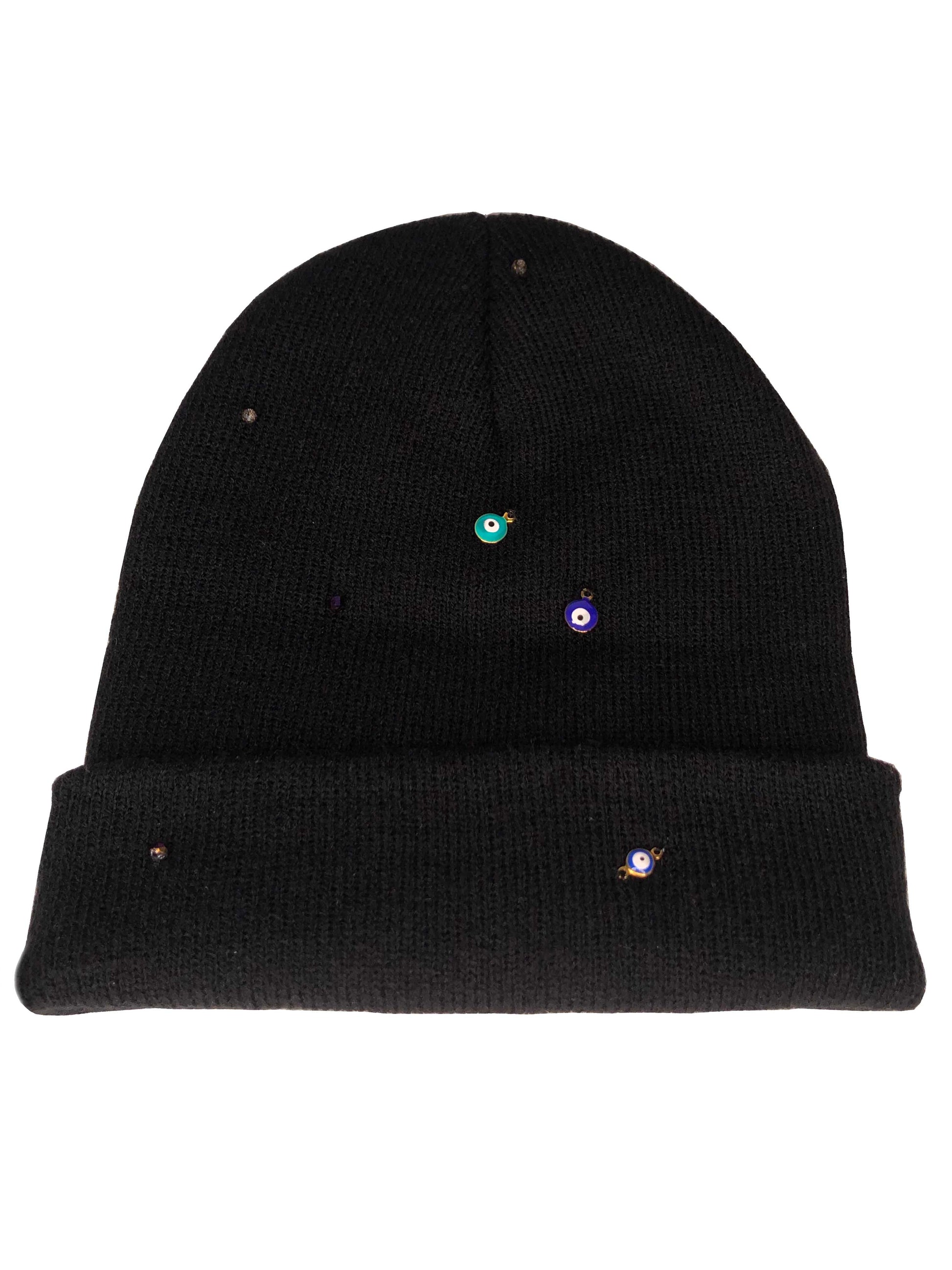 A black beanie accessorized using evil eye charms and crystal beads.