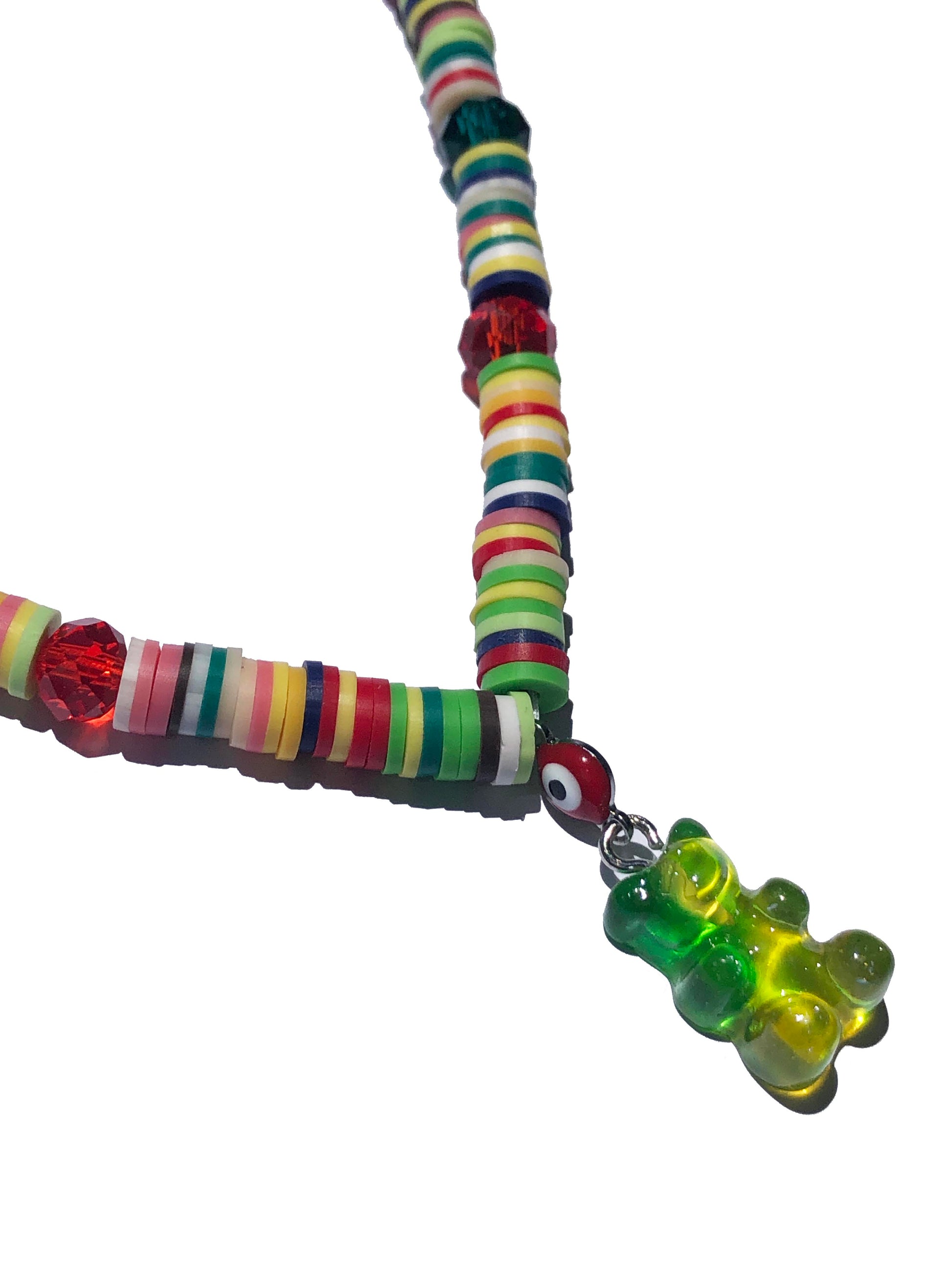 multicolored crystal and glass beaded necklace with a red evil eye, and green and yellow gummy bear-like charm