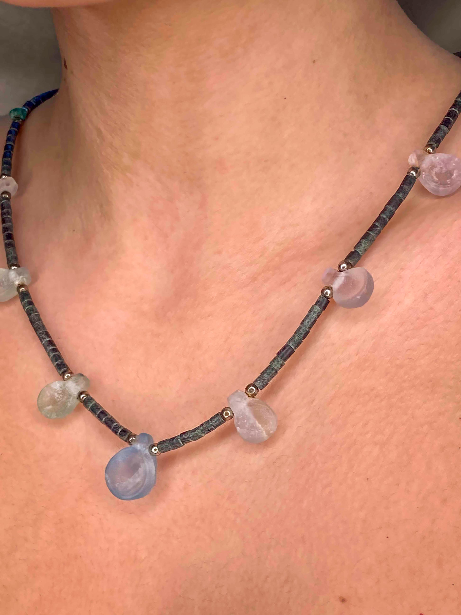 Handcrafted beaded necklace made using carved crystal quartz, turquoise, silver balls, and granite cylinder beads.