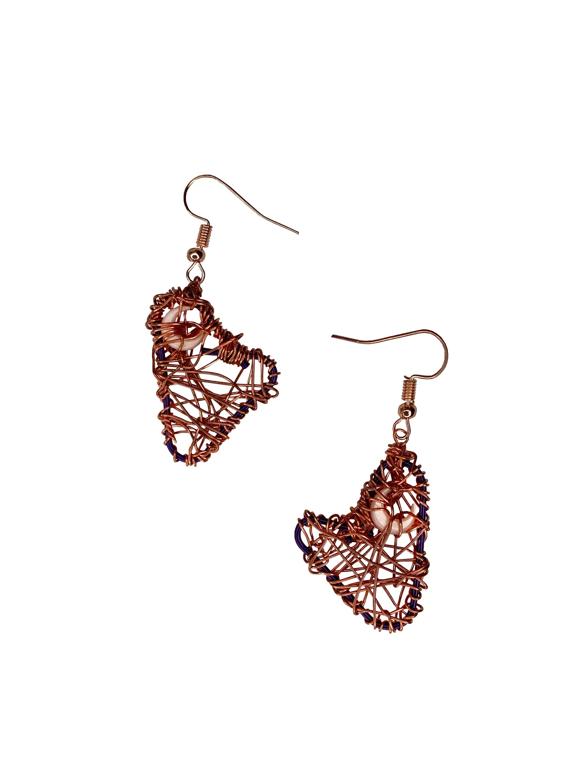 A pair of handmade copper wire wrapped crescent moon earrings. 