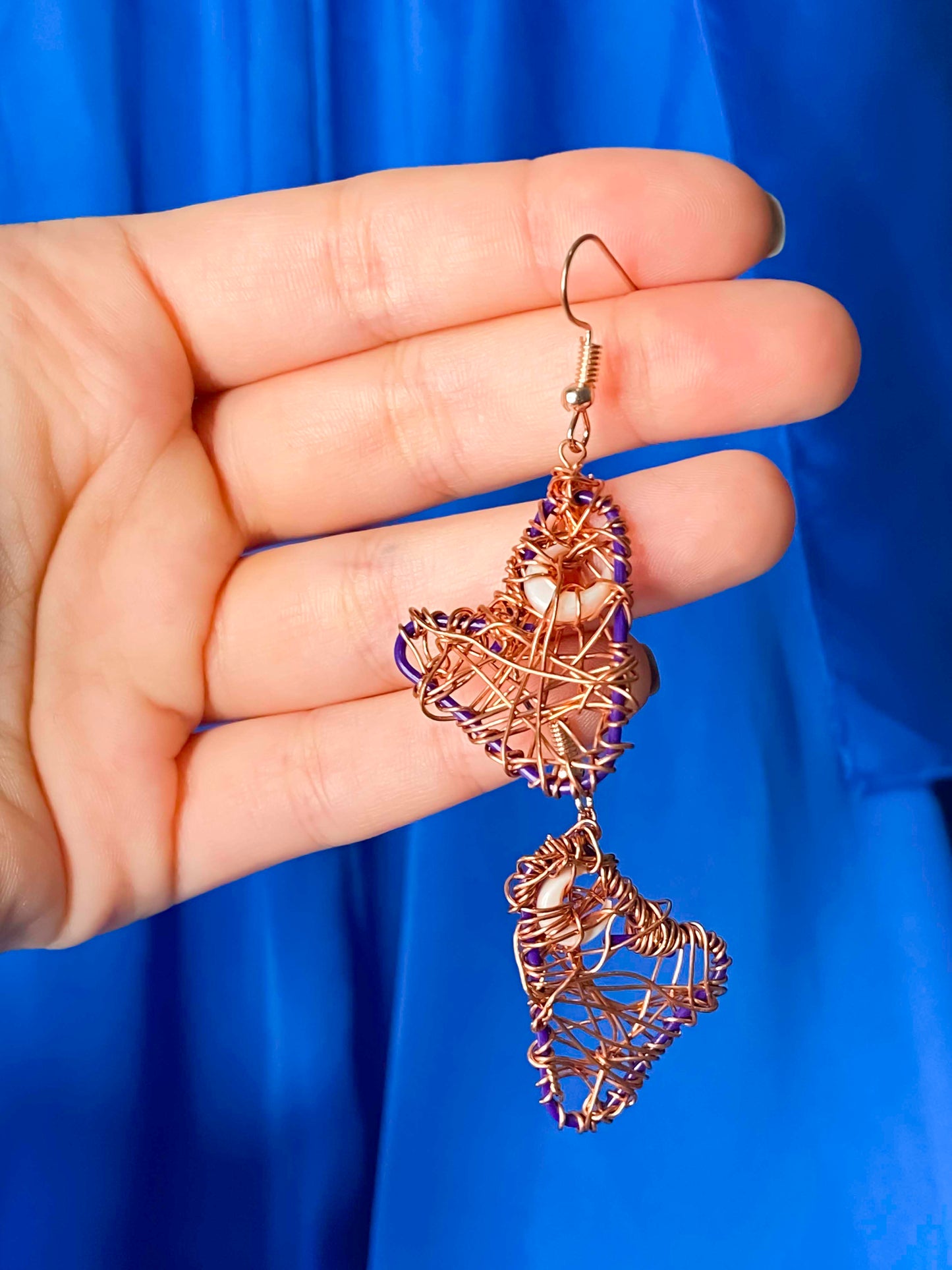 A pair of handmade copper wire wrapped crescent moon earrings.