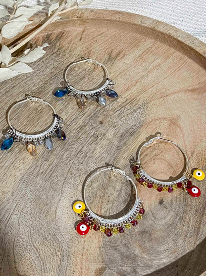 Handmade red and yellow evil eye charm and crystal beaded silver hoops. 