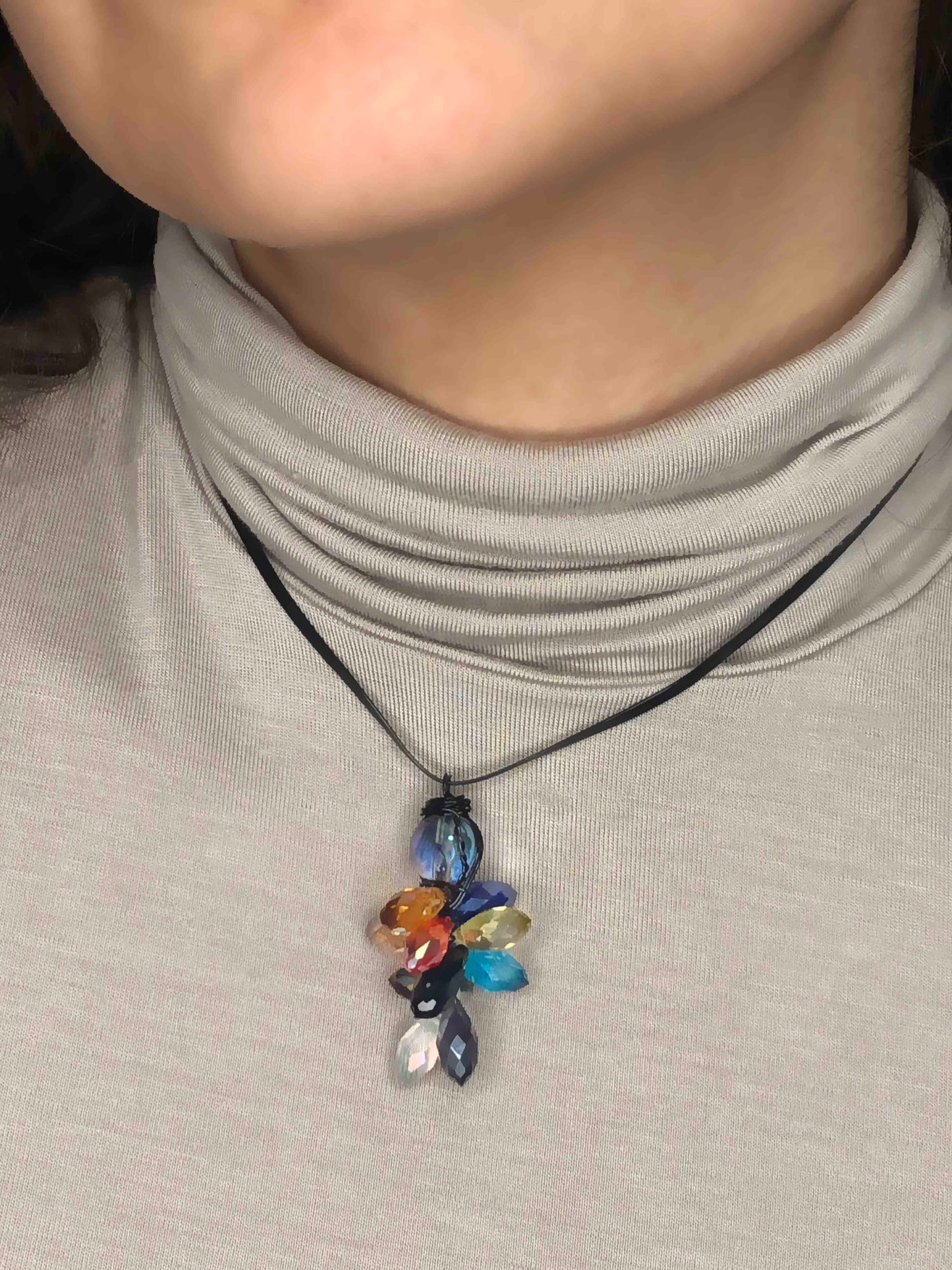 handcrafted wire wrapped crystal necklace made using multicolored teardrop crystal beads with a glass ball bead on top