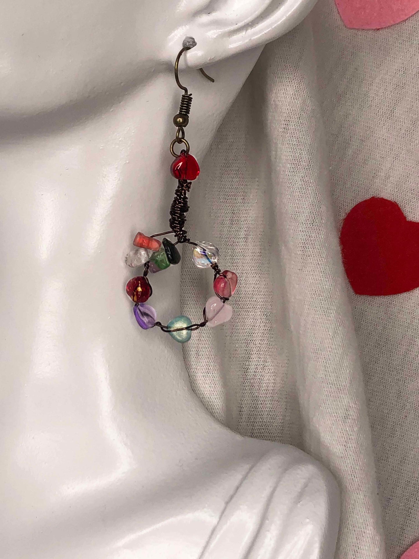 Handmade wire wrapped drop dangle earrings with multicolored heart beads and gemstones.