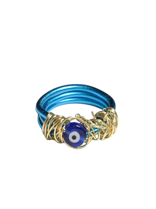 handcrafted ring made from thick blue wire wrapped base with an evil eye charm centerpiece wrapped in thin golden wire