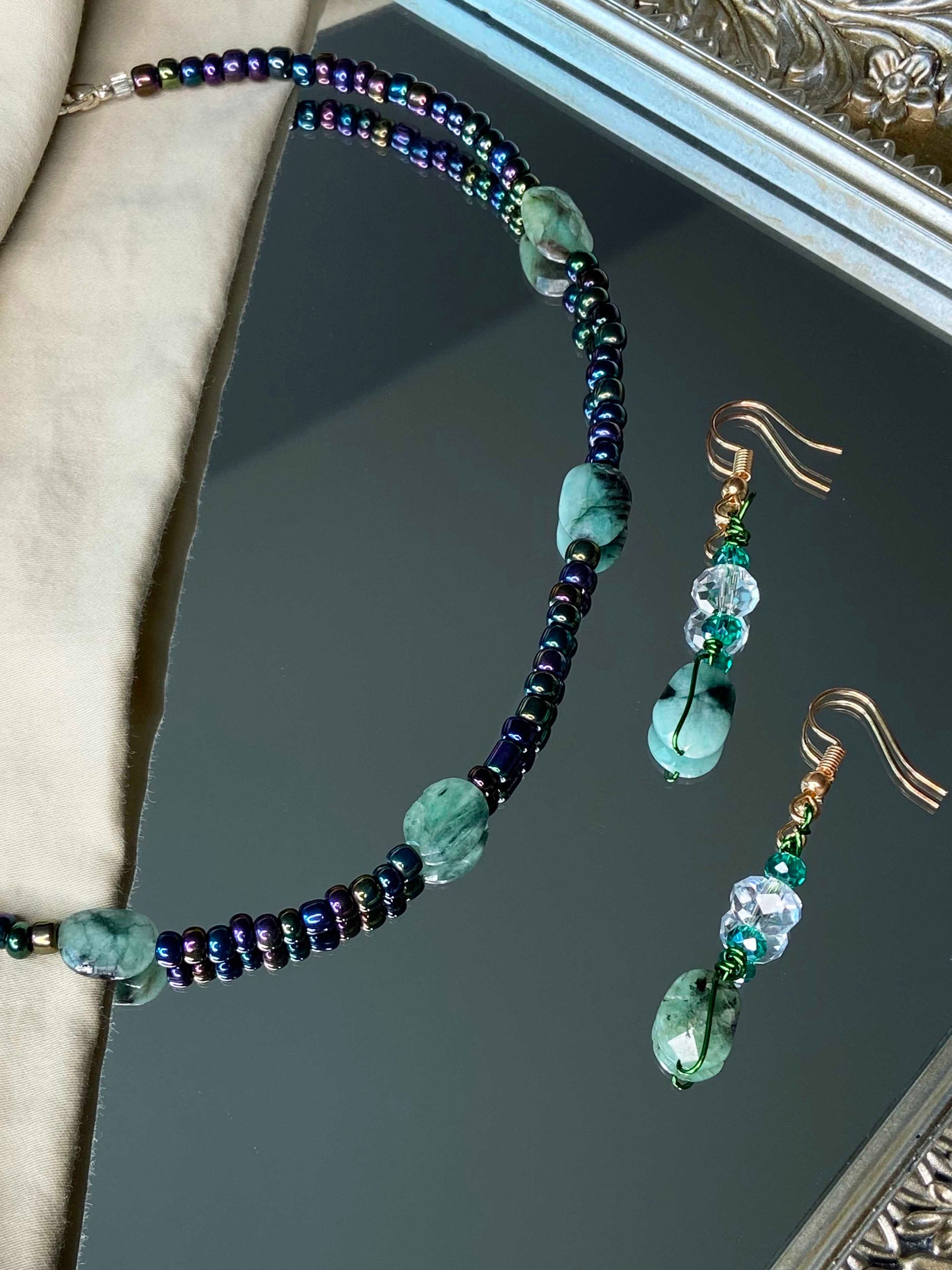 A matching emerald stone necklace and earrings set.