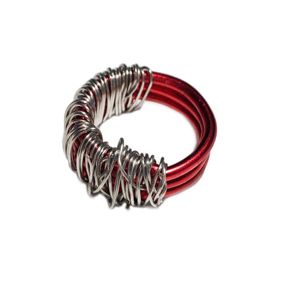 handcrafted ring made using a wire wrapped thick red base with metallic wire detailing 