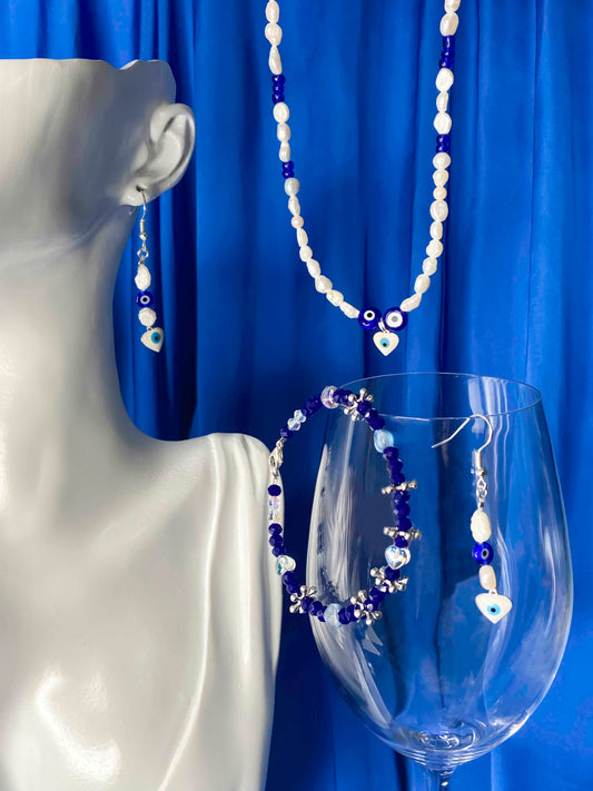 Handmade freshwater pearl, glass & crystal beaded bracelet, necklace, and earrings set made with a blue nazar amulet, and white evil eye charm.