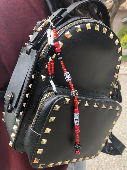 Red, white and black beaded bag charm with black star, stone, and Swarovski ball. Spelled out using letter beads are yes and no.