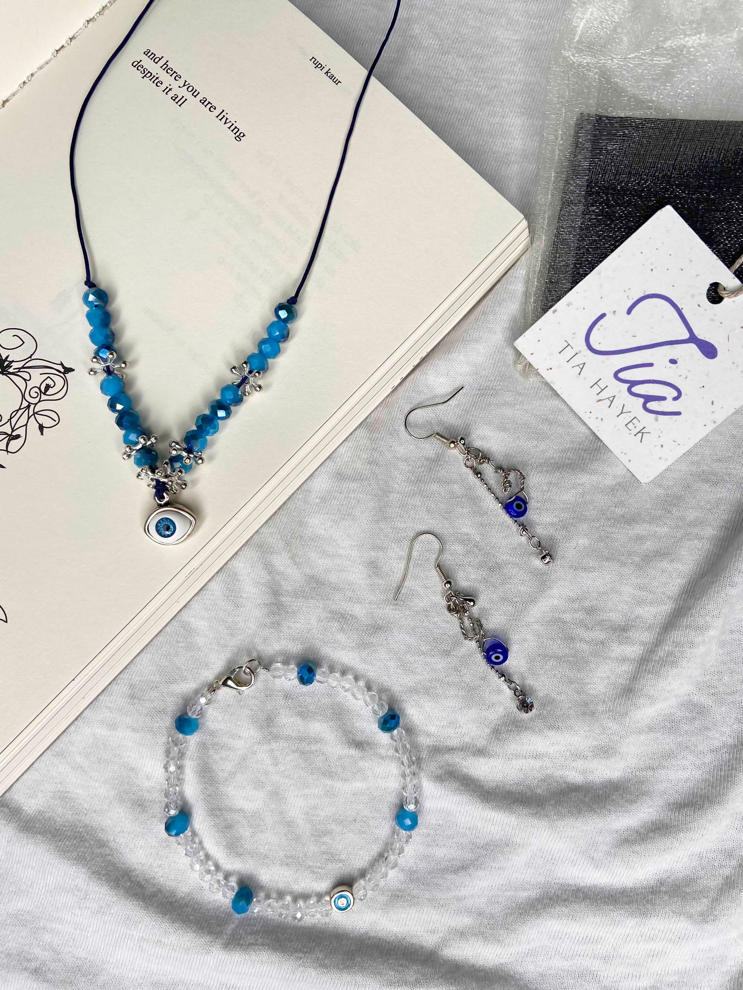 A matching handcrafted necklace, bracelet and earrings evil eye and crystal beaded set. 