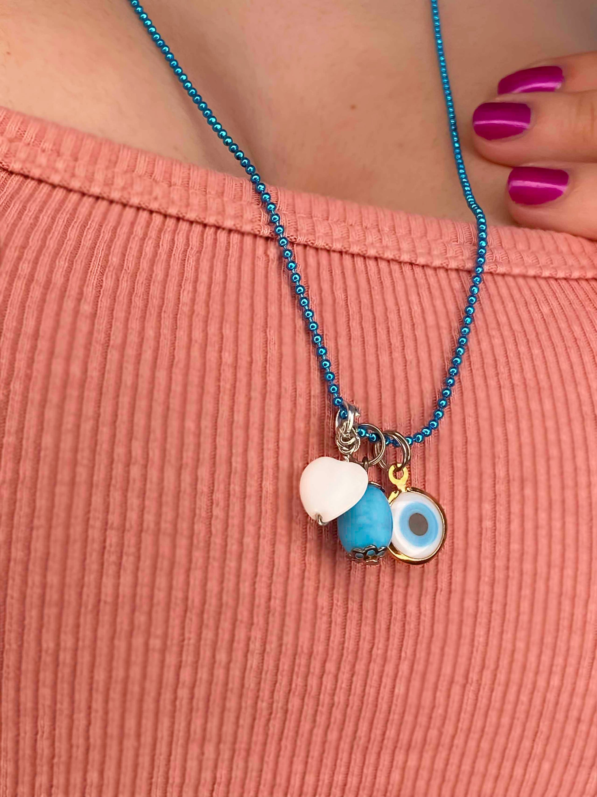 Handmade turquoise stone, evil eye, and white heart charm pendant. 
