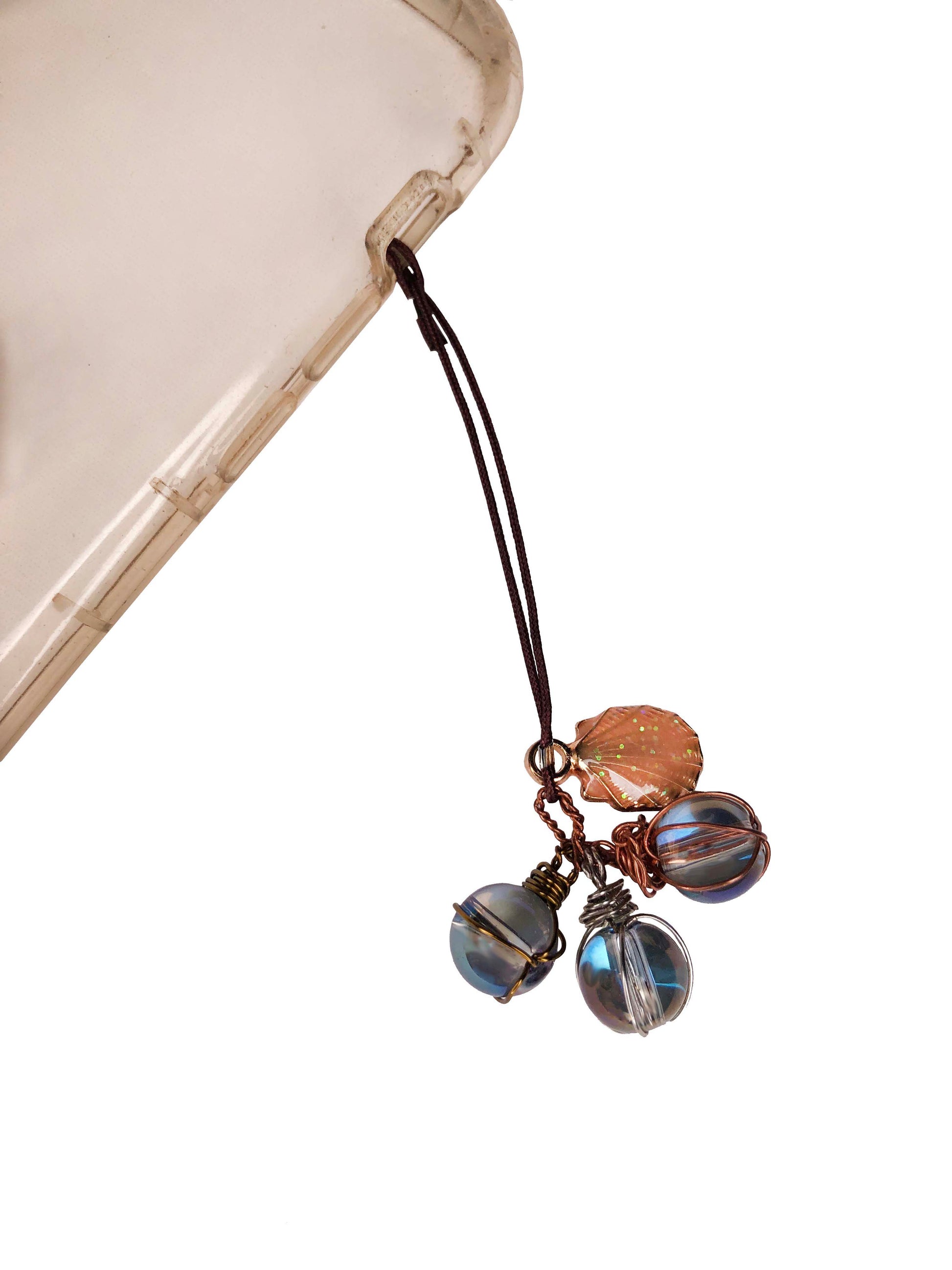 handmade phone charm with three wire wrapped glass beads and a sea shell charm.