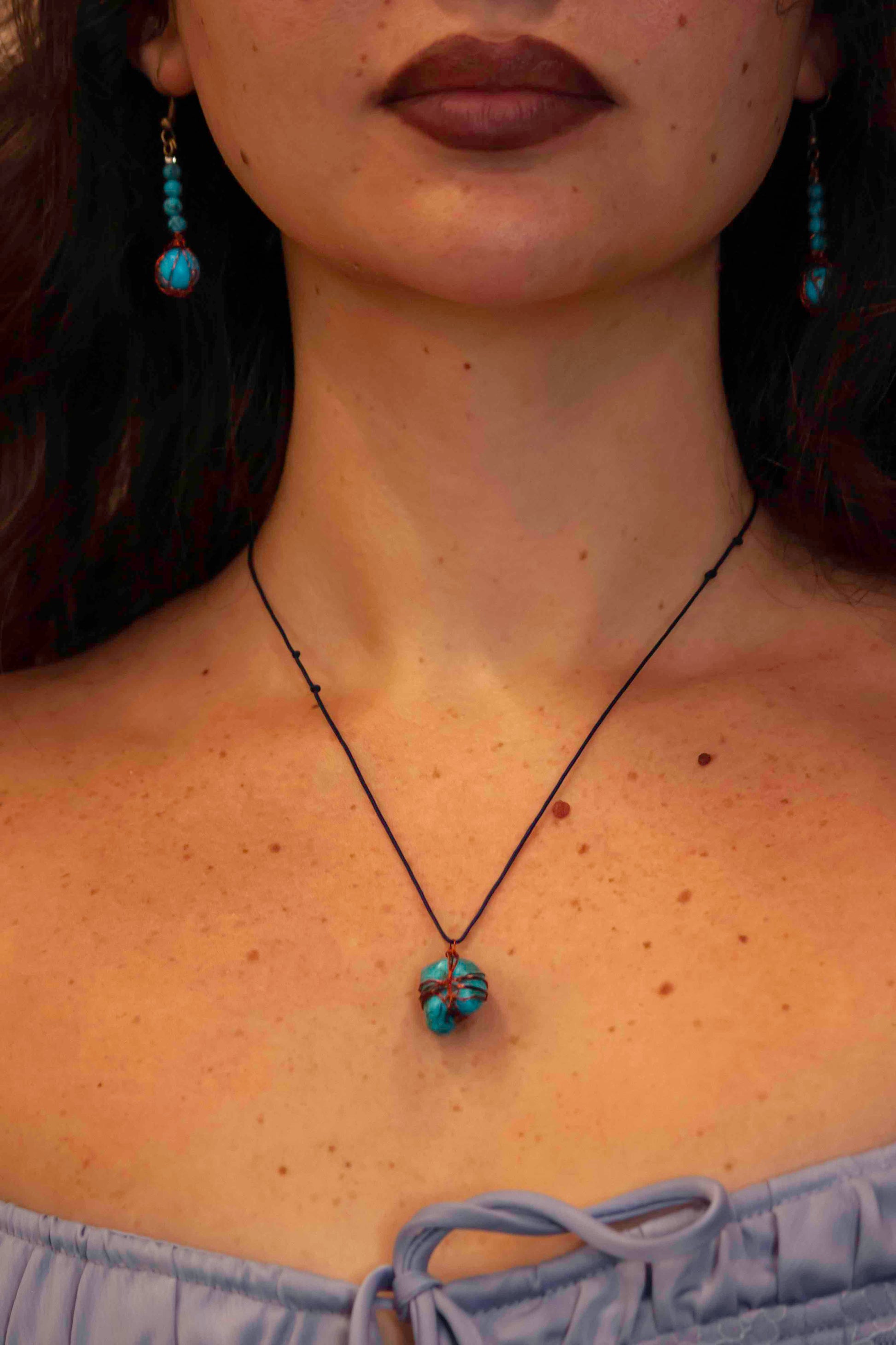 A pair of handcrafted wire-wrapped and beaded turquoise earrings, and matching pendant necklace.