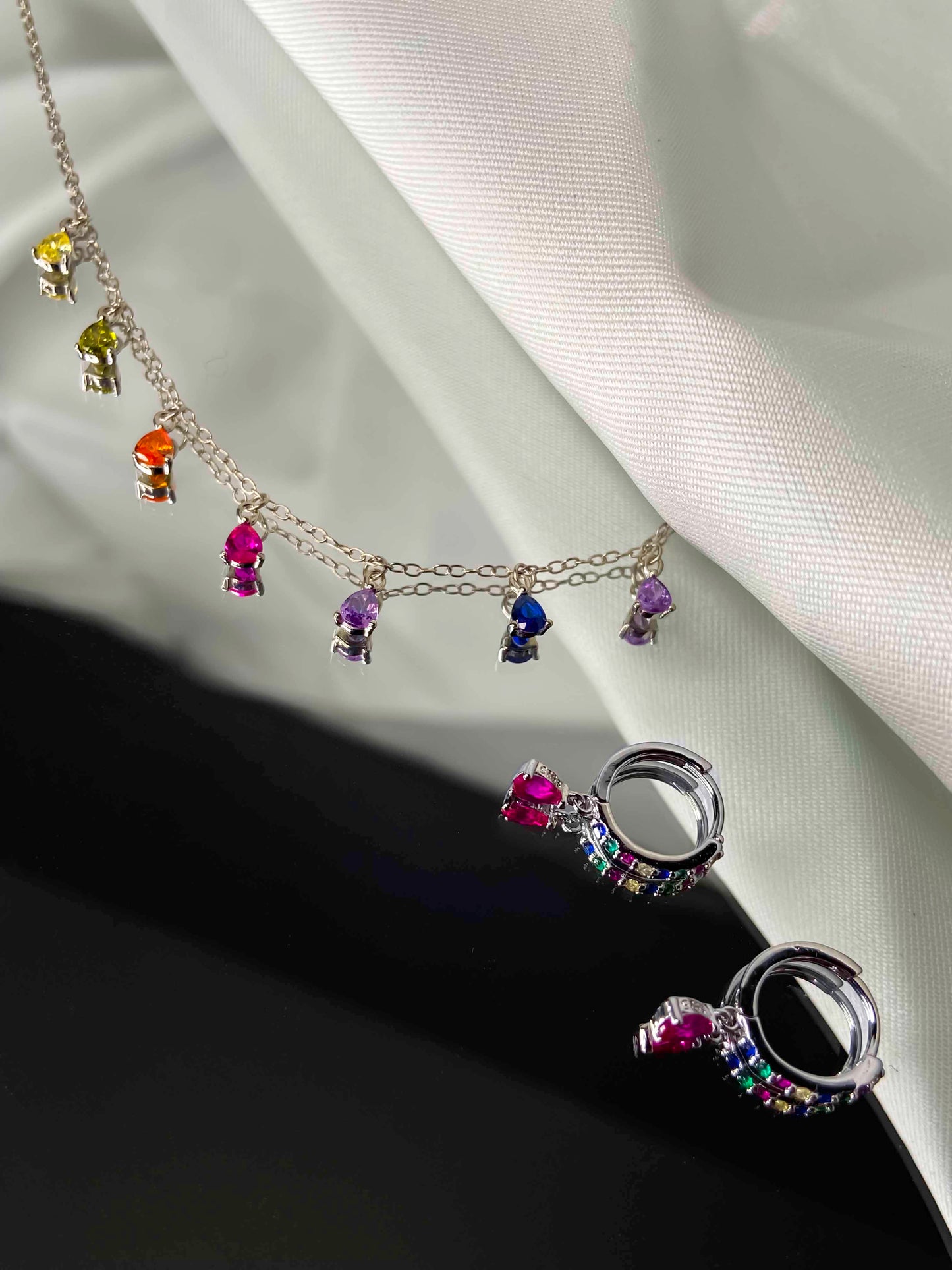 925 sterling silver huggie hoop earrings and chain necklace with multicolored zirconia stones. 