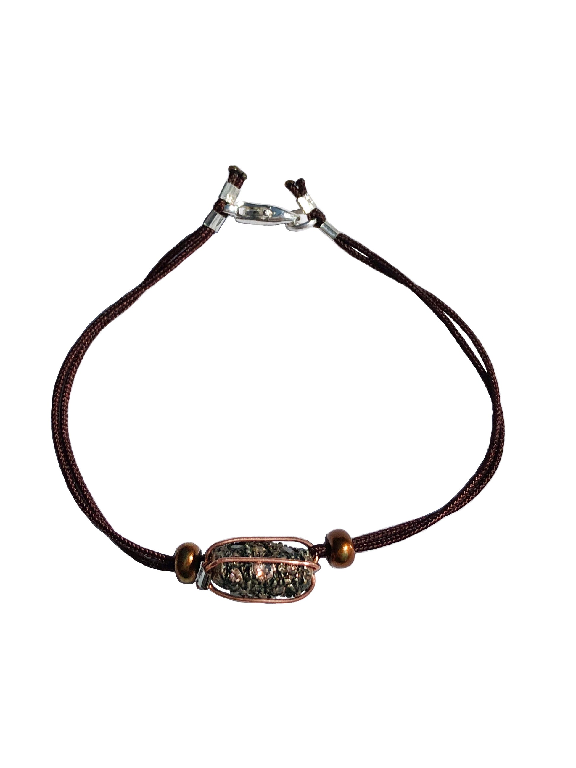 Handcrafted copper wire wrapped zirconium stone bracelet with two bronze beads.