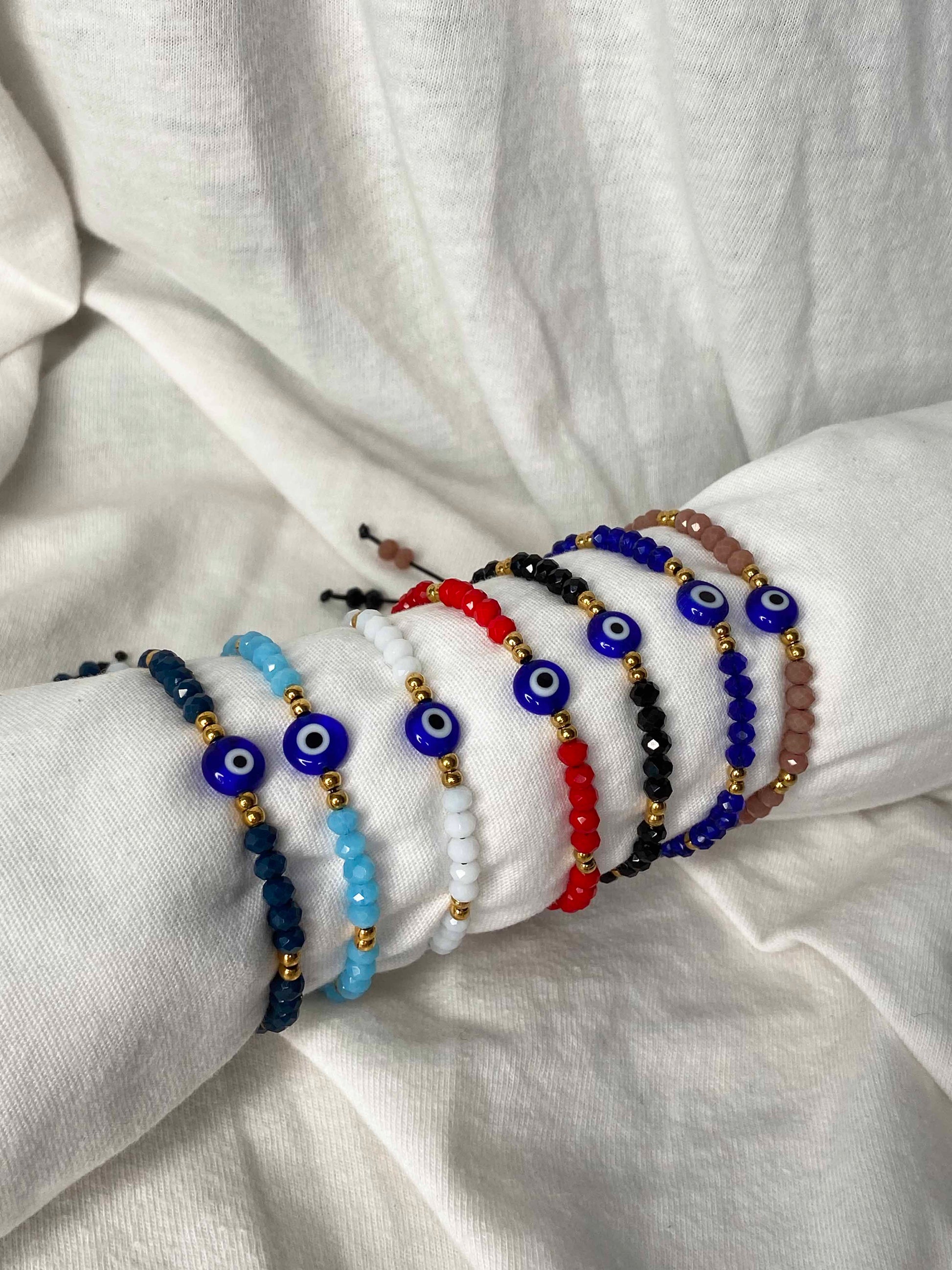 Handmade crystal beaded nazar amulet bracelets with sliding knot ties. 