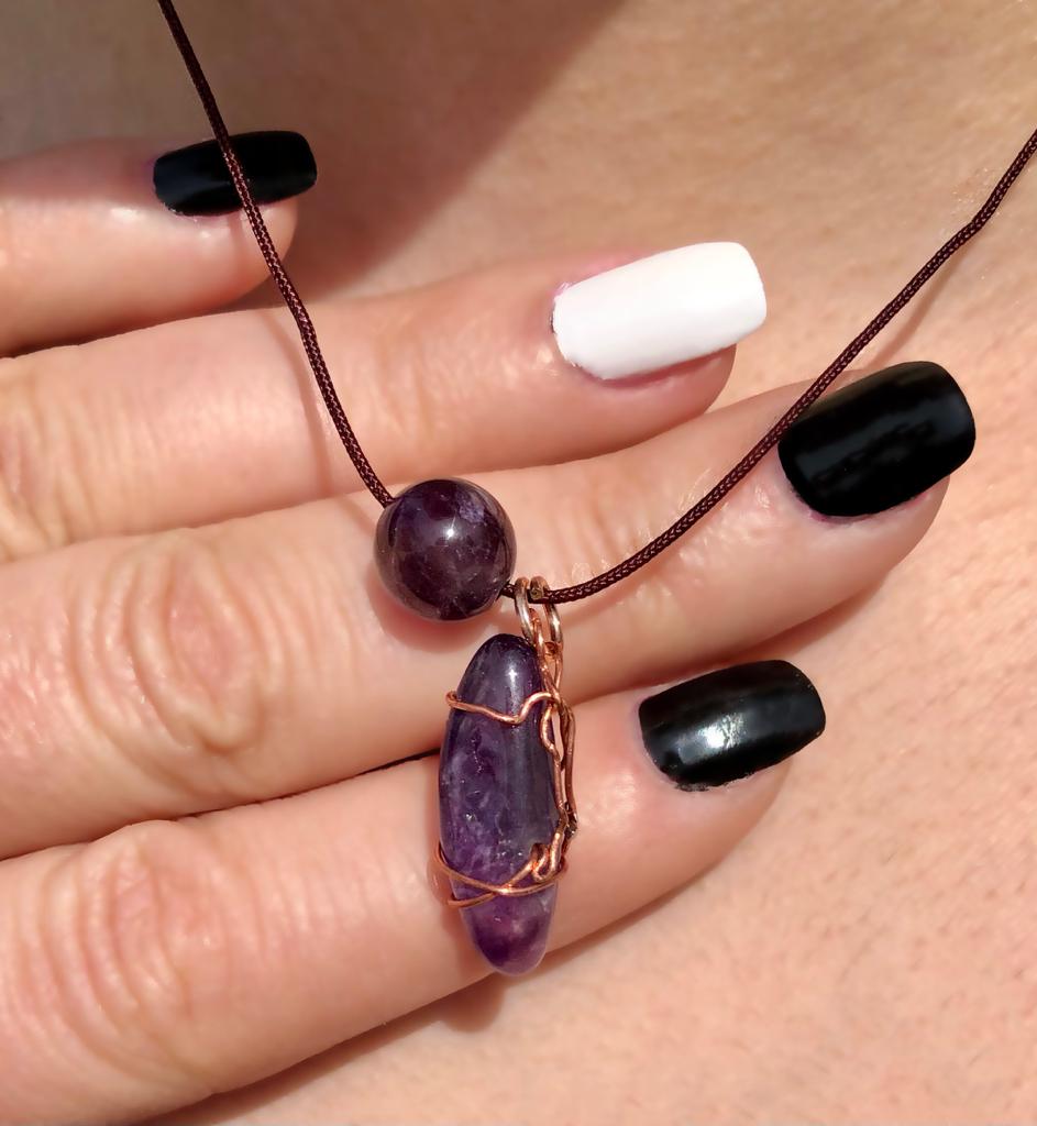 copper wire wrapped amethyst stone with a large purple glass bead 