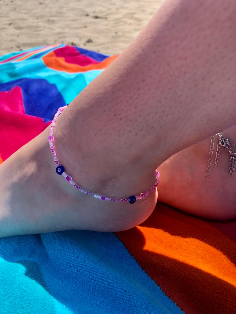 handcrafted pink glass bead anklet with three blue evil eye charms