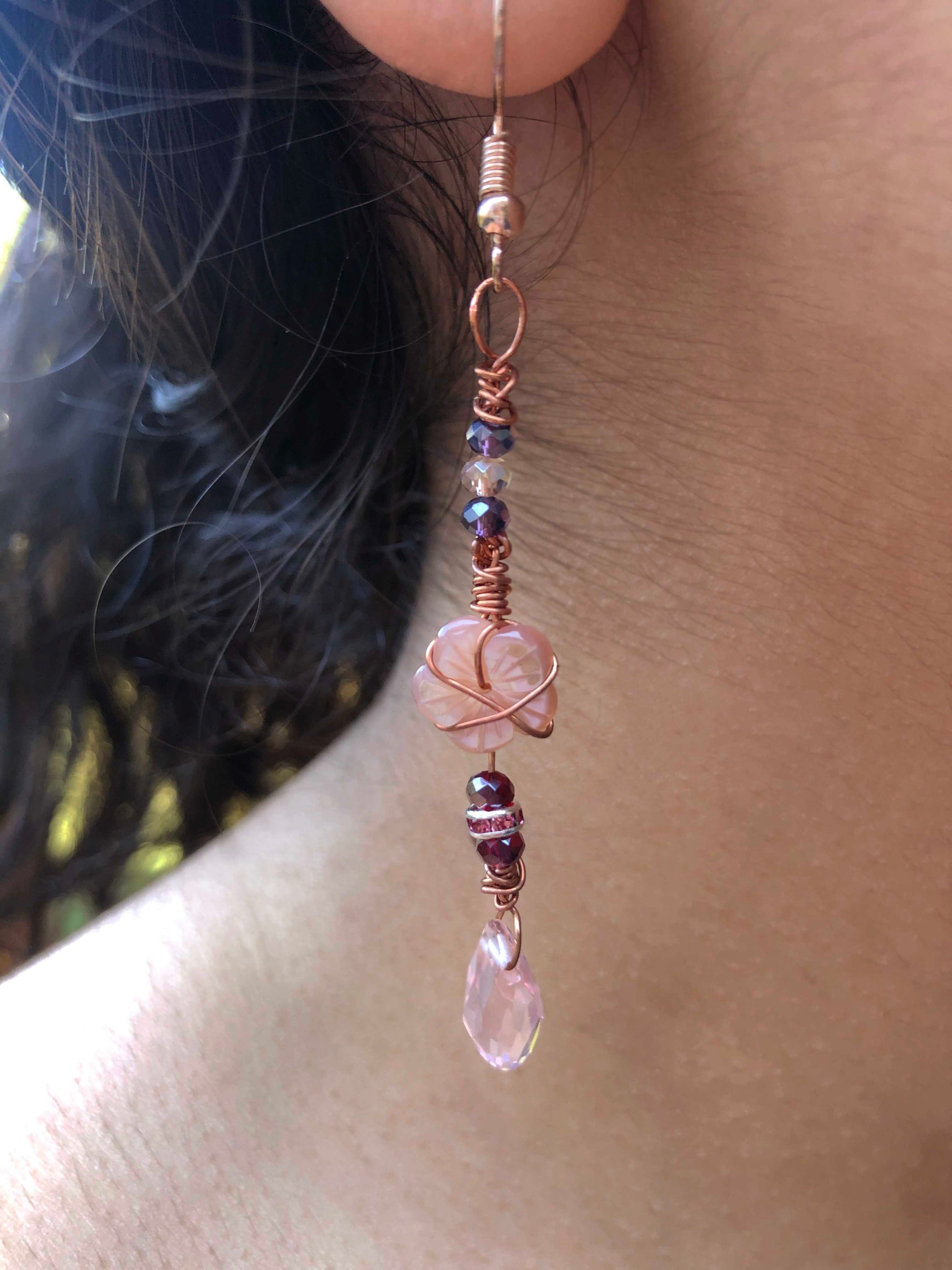 A pair of handmade wire wrapped beaded crystal and flower pearl charm earrings.