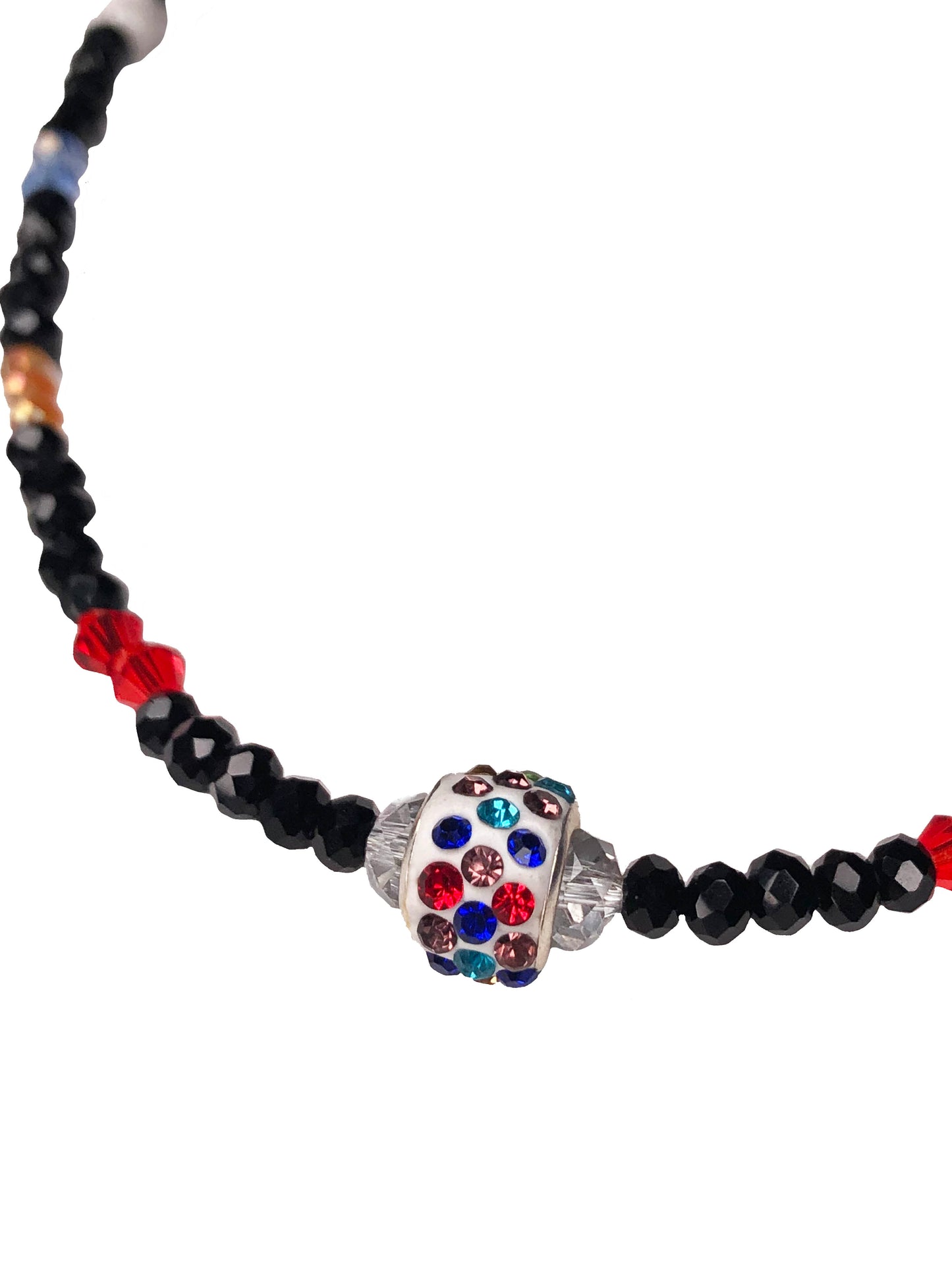 Handcrafted beaded crystal necklace made using black, blue, clear, orange, purple, and red crystal beads with white glass beads. At its center is a multicolor rhinestone charm.
