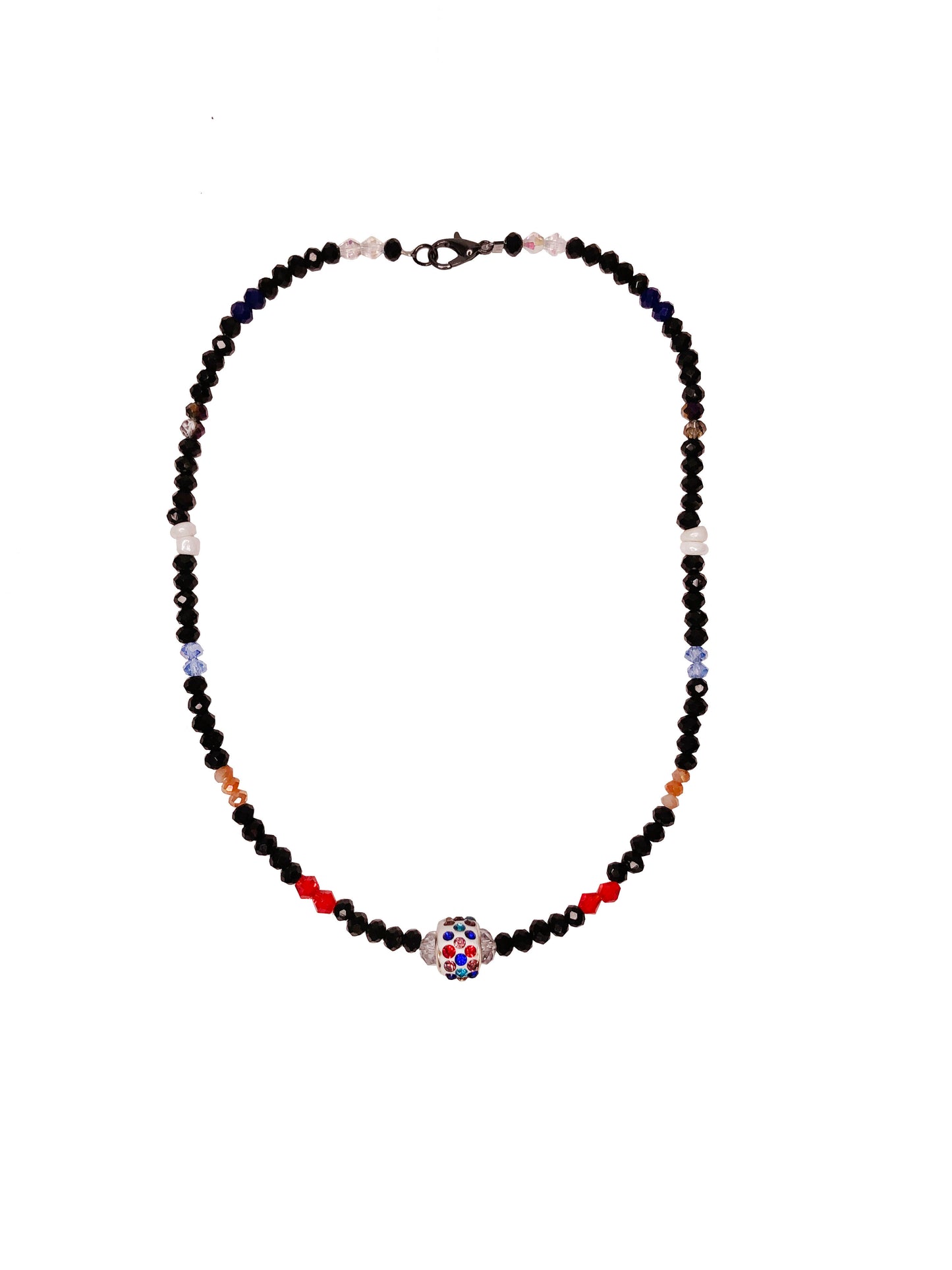 Handcrafted beaded crystal necklace made using black, blue, clear, orange, purple, and red crystal beads with white glass beads.  At its center is a multicolor rhinestone charm.