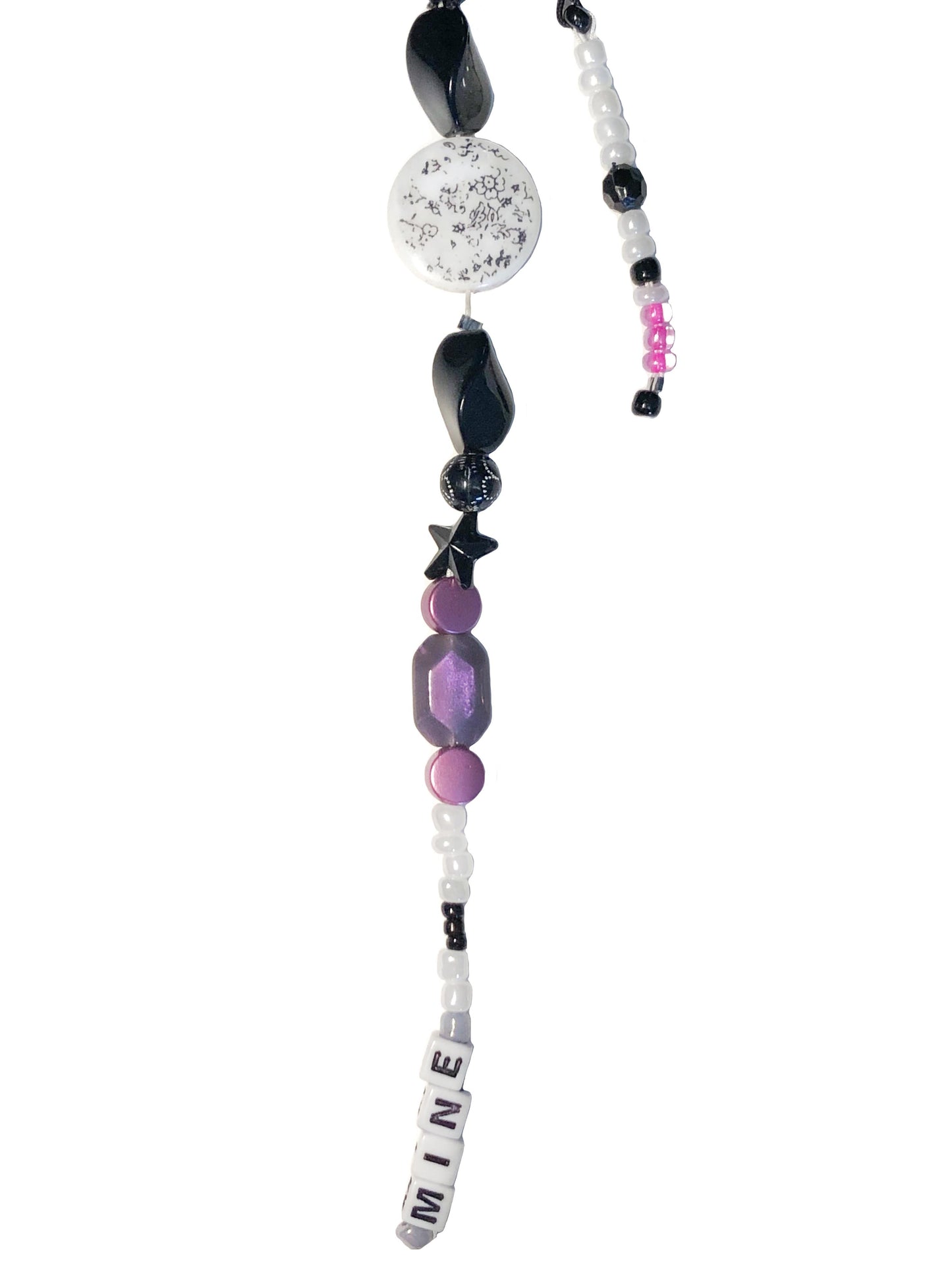 White, black, purple and pink beaded bag charm. Handcrafted with black stars, a coin floral print charm, and mine beaded using letter beads.