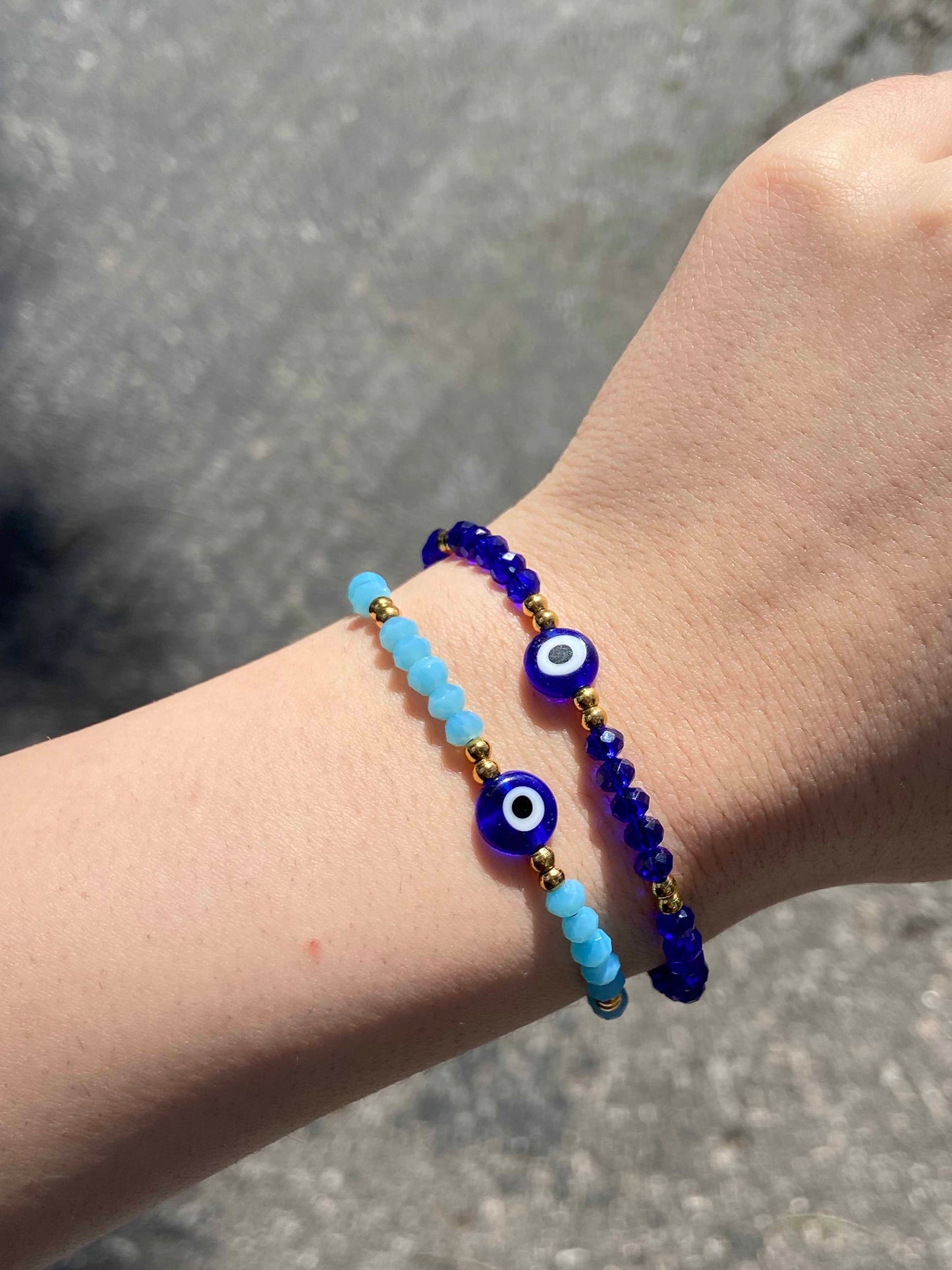 Handmade blue crystal beaded nazar amulet bracelets with sliding knot ties. 