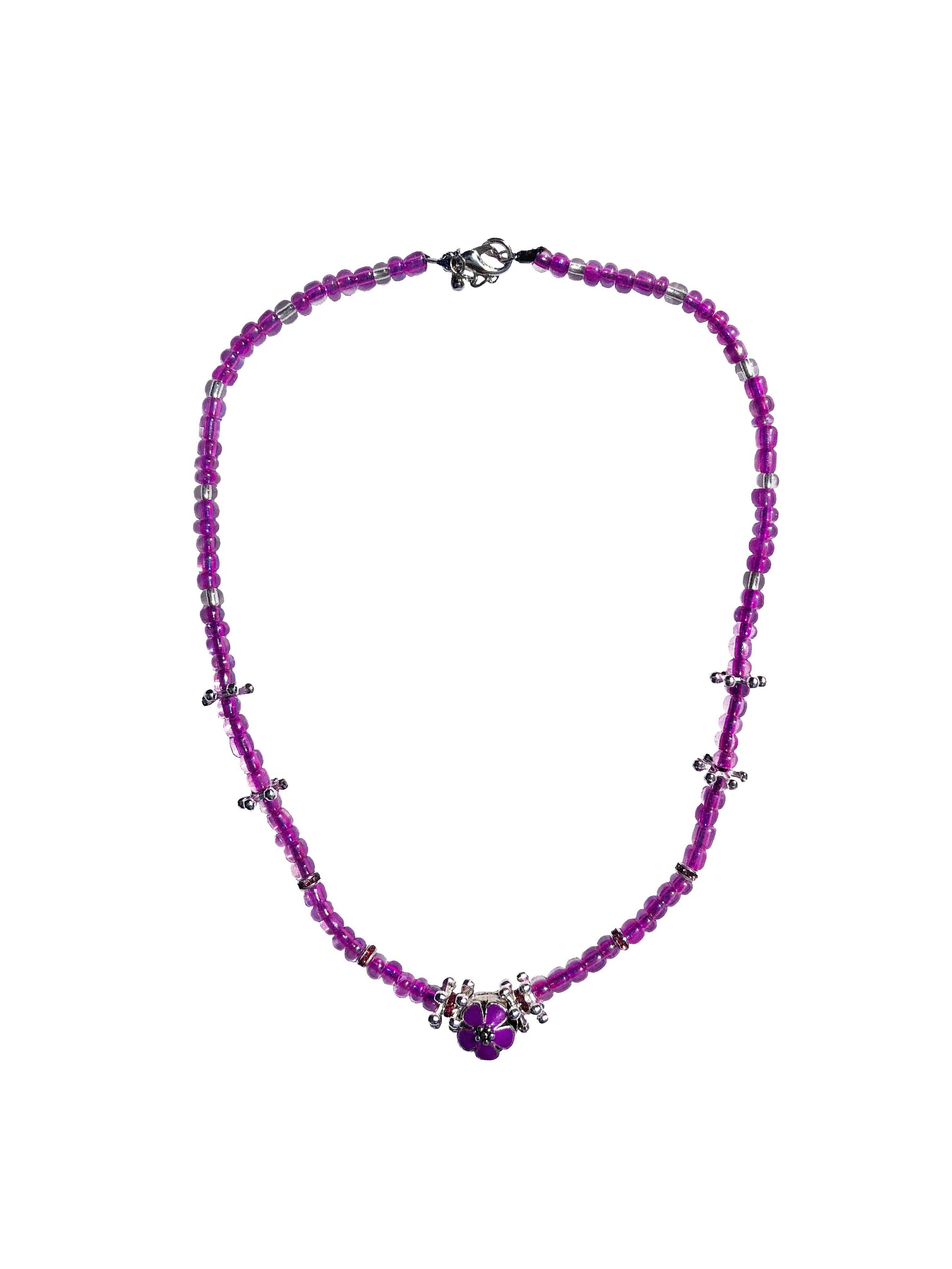 Handmade glass beaded necklace with silver flower charms, and a purple flower charm centerpiece. 