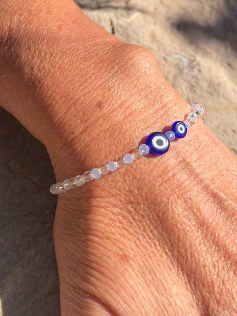 white crystal beads handcrafted bracelet with two blue evil eye charms