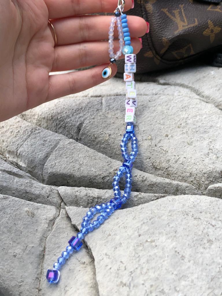Blue and white crystal beaded bag charm with whatever spelled out using letter beads and an evil eye charm.