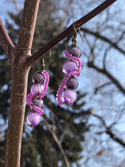 Beaded pink glass wire wrapped disco ball purple and black beaded earrings. 